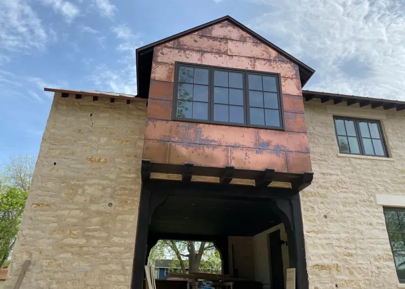 Copper metal panel facade on a stone building for Skylight Installation in Cottleville